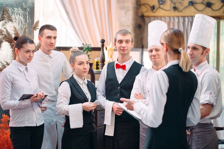 restaurant,manager,and,his,staff,in,kitchen.,interacting,to,head